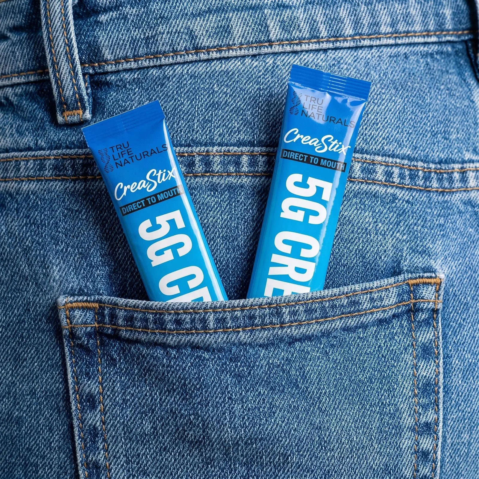 Two Blue Razz CreaStix sticks in a back jean pocket
