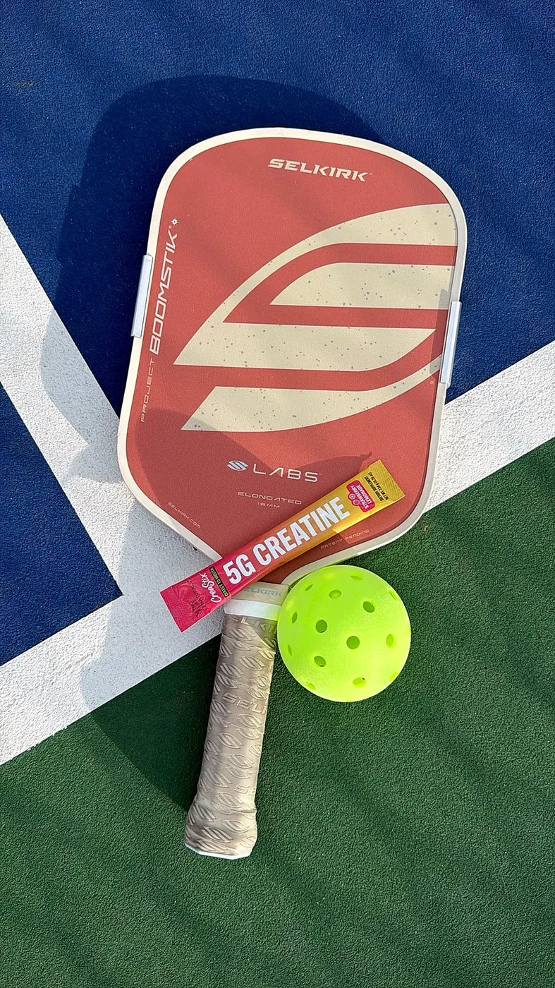 CreaStix beside pickleball gear on a court