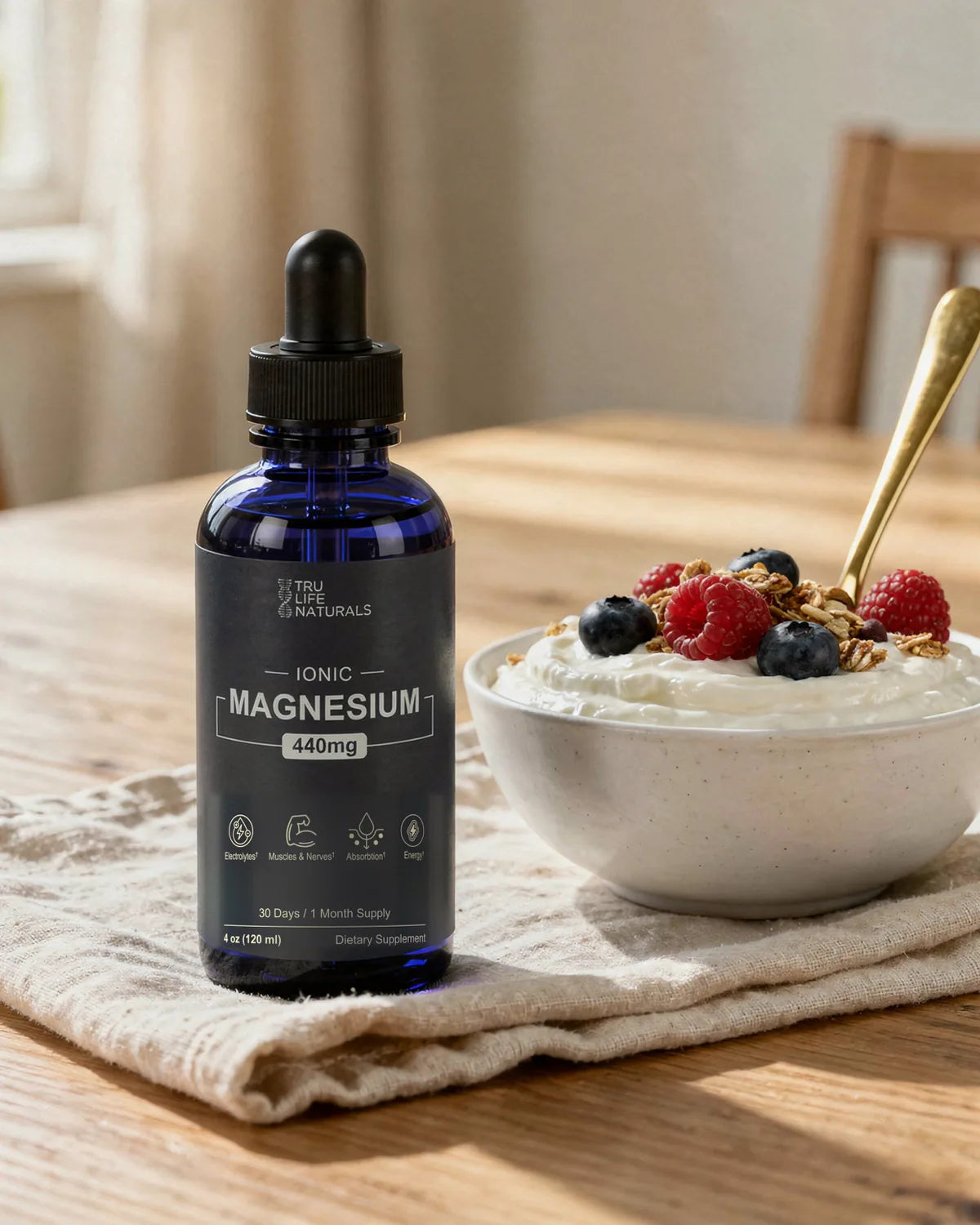 Ionic Magnesium bottle next to a bowl of yogurt with berries